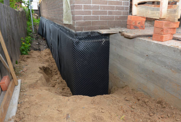 Happy homeowners after waterproofing job in Hemlock